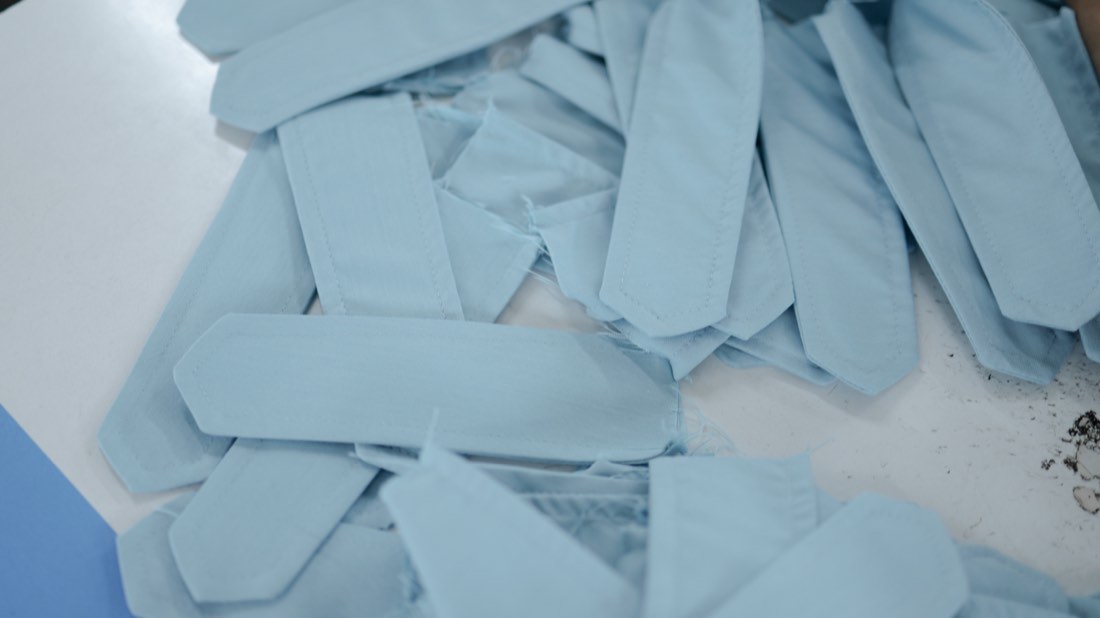 Stacks of cut fabric pieces bundled ready for stitching