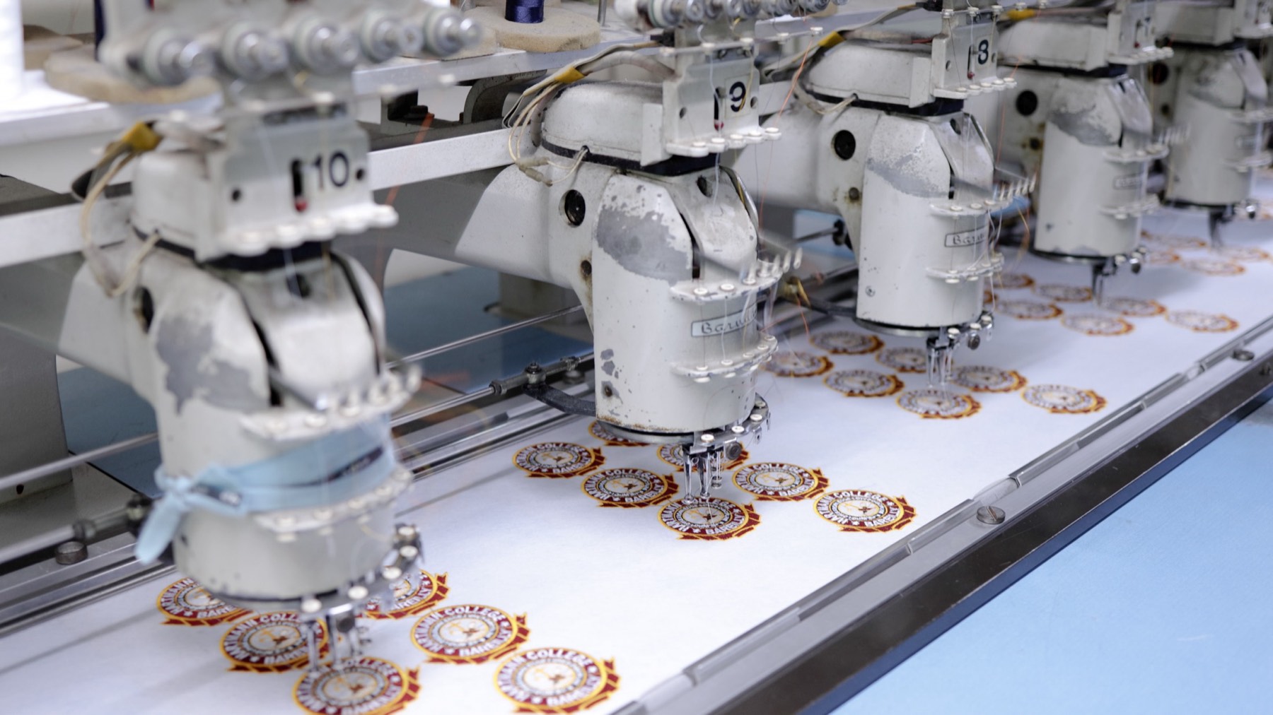 A multi-head embroidery machine running with coloured thread