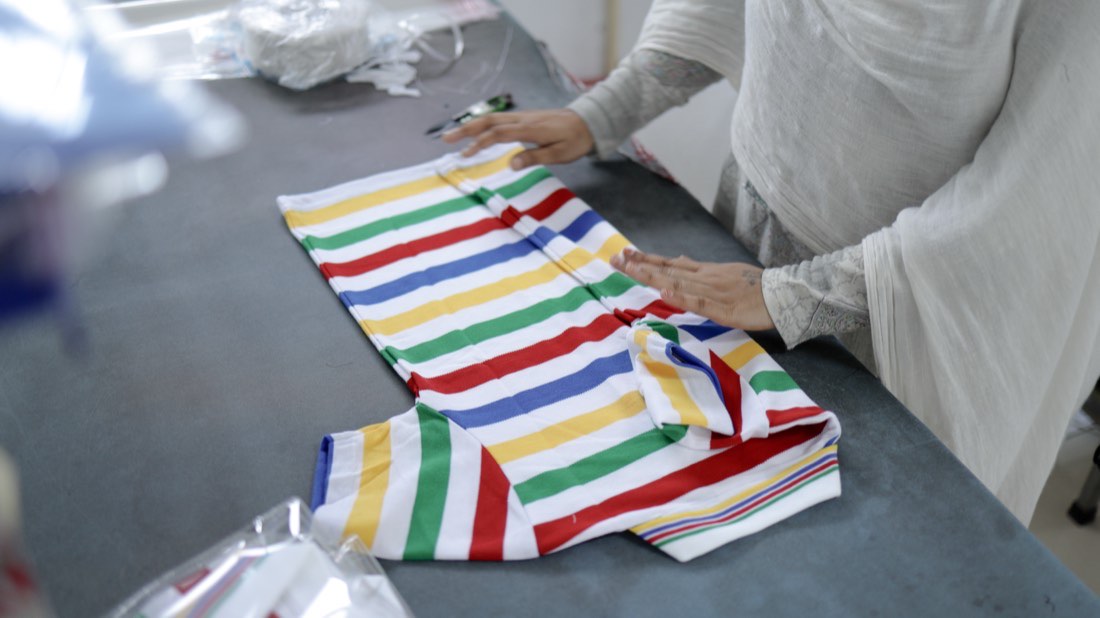 Stacked bolts of striped shirting fabric