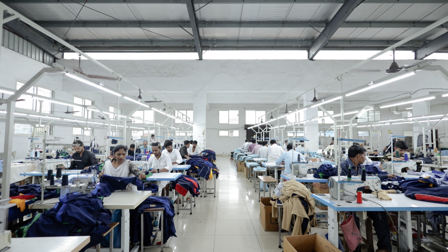 The full production floor with operators at every machine