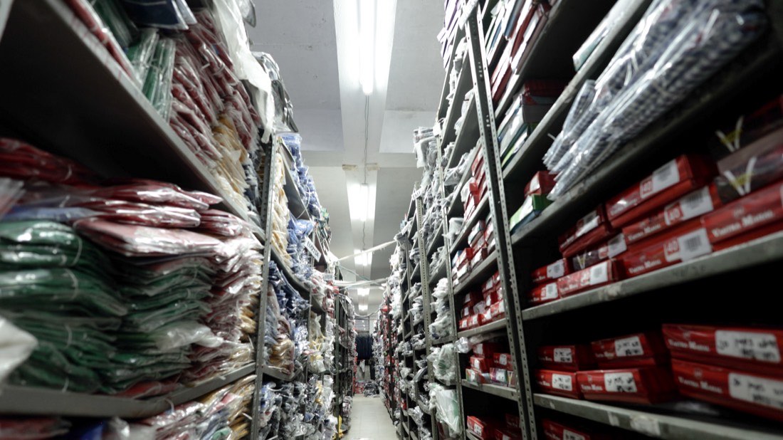 Aisles of packed uniforms and boxed stock in the Vastra Mahal store